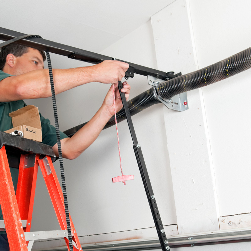 man repairing a garage door